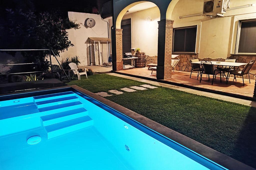 a swimming pool in the yard of a house with a patio at Cilento Loft with Private Pool in Ascea