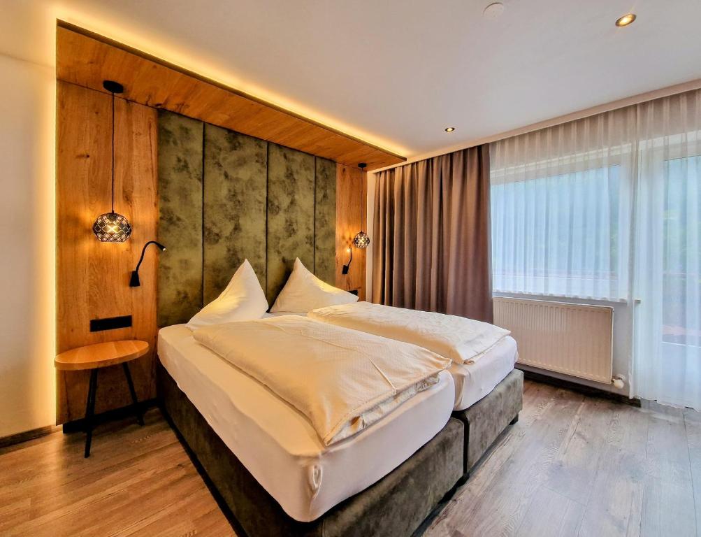 Postel nebo postele na pokoji v ubytování Hotel Grieserhof