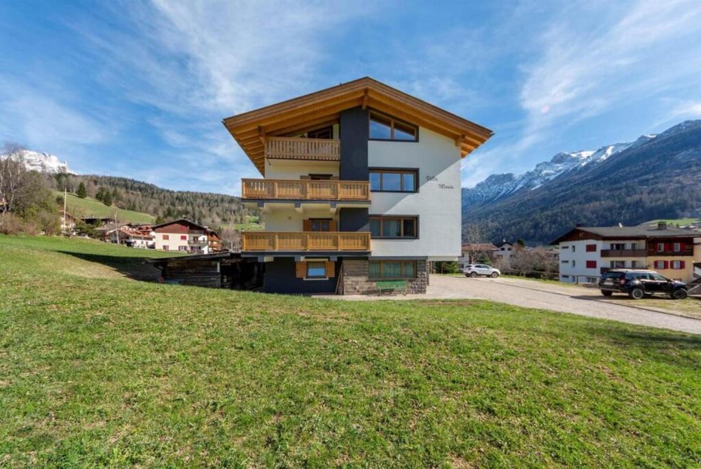 a house on a hill with mountains in the background at Villa Maria in Moena