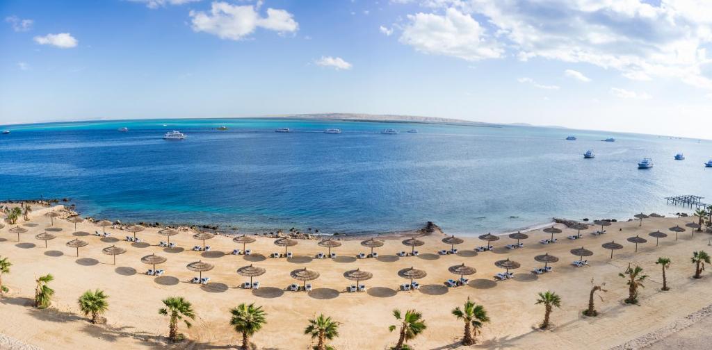 an aerial view of a beach with umbrellas and the ocean at Sky View Suites Hotel in Hurghada