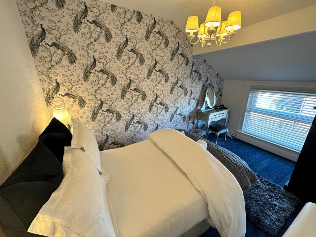 a bedroom with a bed and a wall at Luxury Loft suite ideal theatre digs in Blackpool