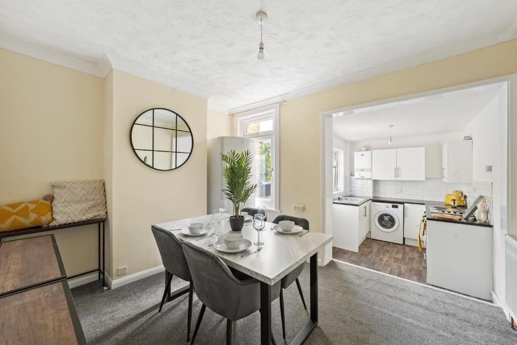 a kitchen and dining room with a table and chairs at Brun Clair House in Chatham