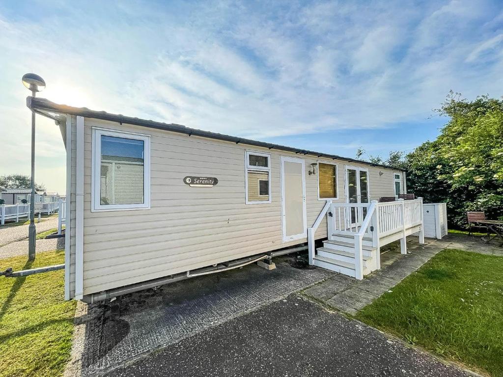 a white tiny house with a porch at 8 Berth, Dog Friendly Caravan At Haven Caister In Norfolk Ref 30031b in Great Yarmouth