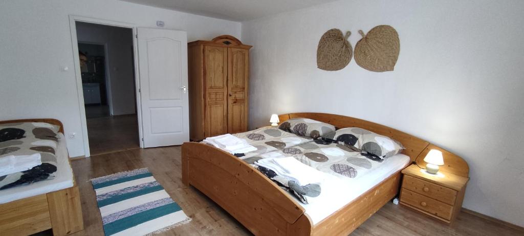 a bedroom with a bed and a dresser at Andrea vendégház in Egerszólát