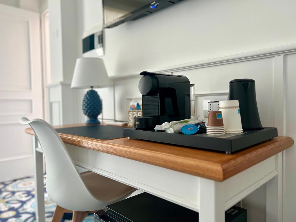 a desk with a chair and a microwave on it at TEA Luxury - Praia a Mare in Praia a Mare