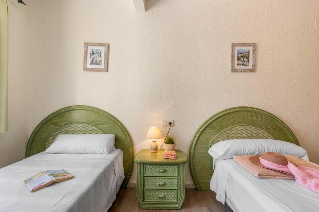 A bed or beds in a room at Apartamento Arenal 3 - PlusHolidays