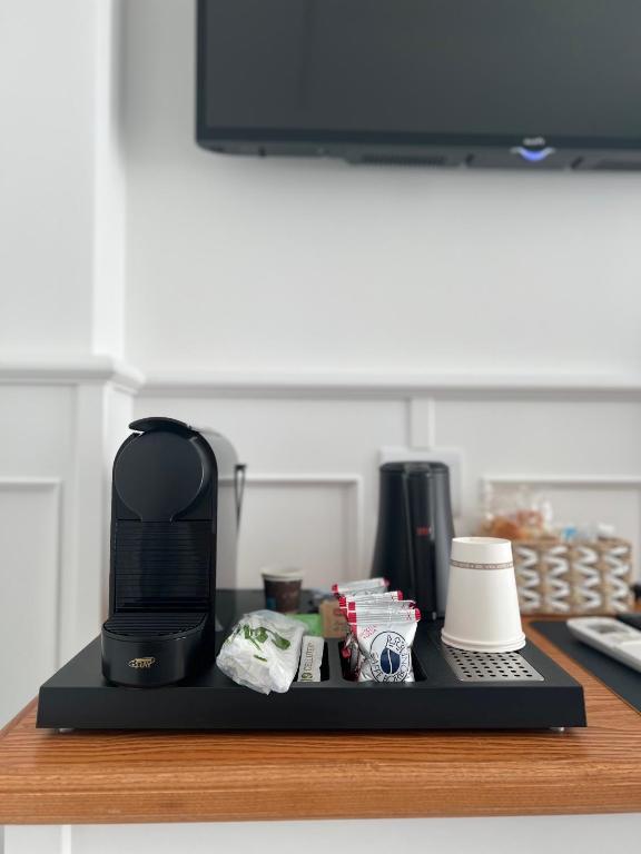 a desk with a coffee maker and a keyboard on it at TEA Luxury - Praia a Mare in Praia a Mare