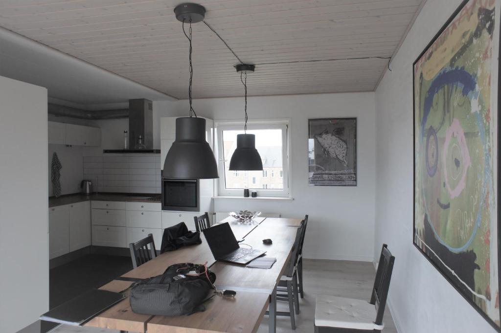 a dining room with a table with a laptop on it at Vesterhavsgade 47. door 25 (id. 076) in Esbjerg