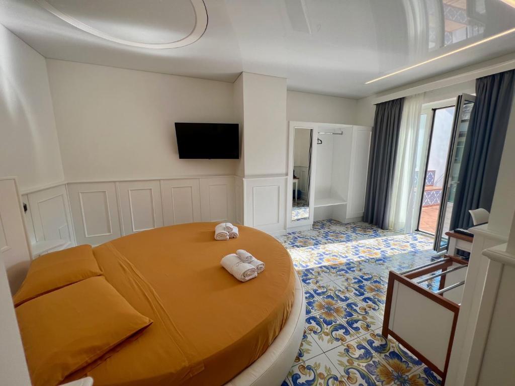 a bedroom with a large bed with towels on it at TEA Luxury - Praia a Mare in Praia a Mare