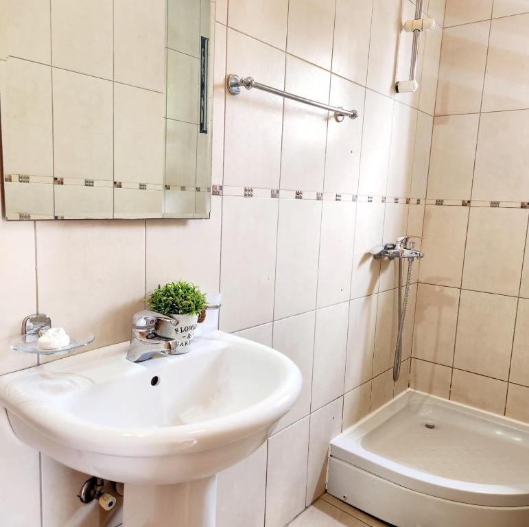 a white bathroom with a sink and a toilet at A step to the sea-Na korak do mora-Studio apartments Bela kuća in Rafailovici