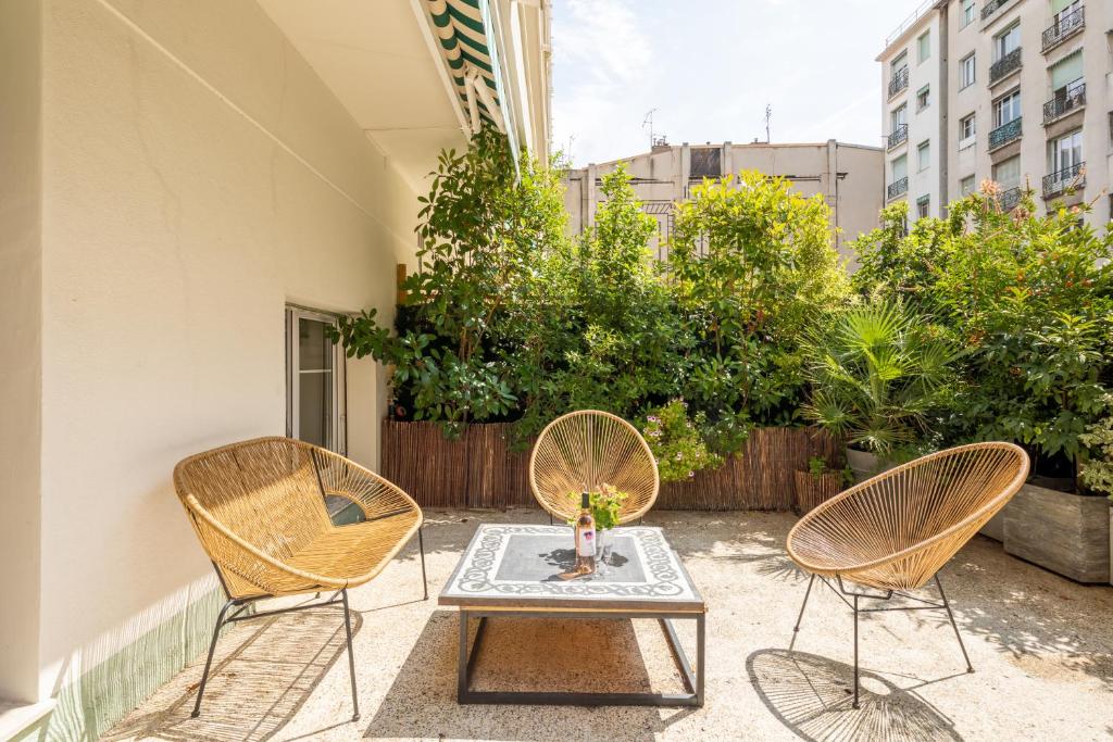 a patio with two chairs and a table with at Peaceful Haven, Terrace in Nice in Nice