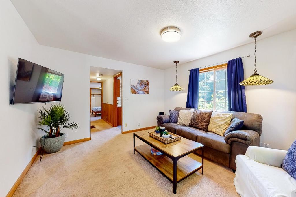 a living room with a couch and a table at Wonder on Whiskey Road in Warrenton