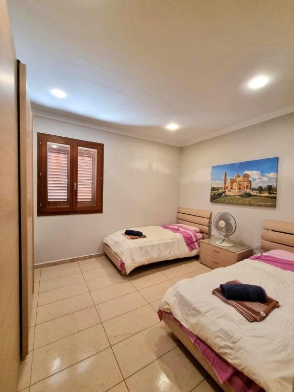 A bed or beds in a room at Fort Chambray Gozo