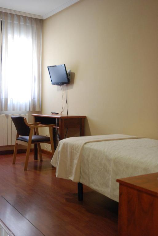TV a/nebo společenská místnost v ubytování Apartahotel FC Catedral