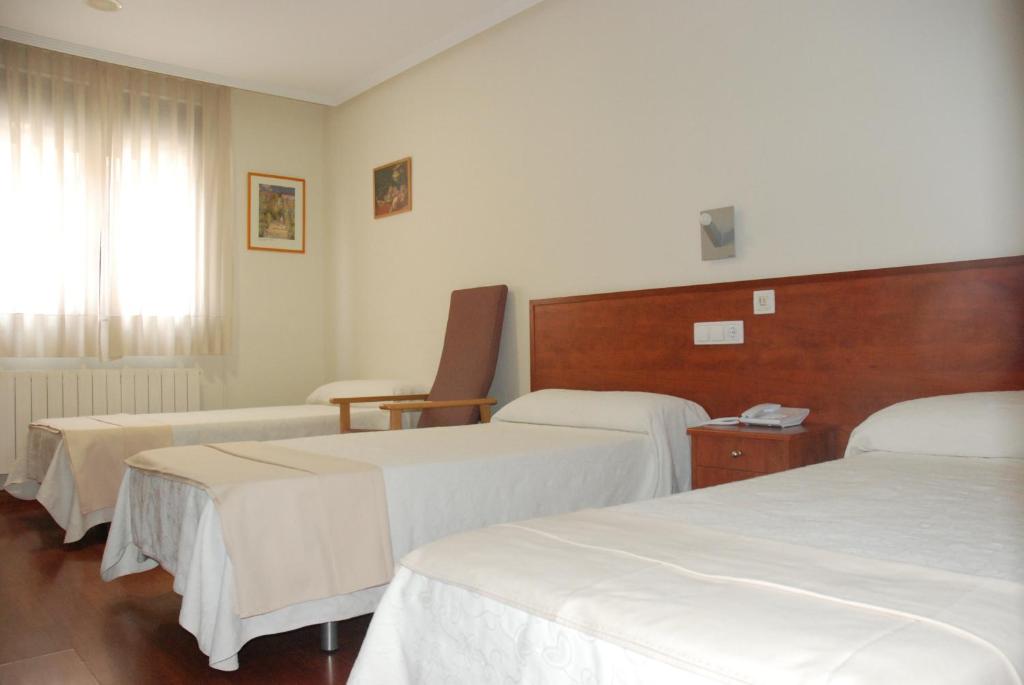 Postel nebo postele na pokoji v ubytování Apartahotel FC Catedral