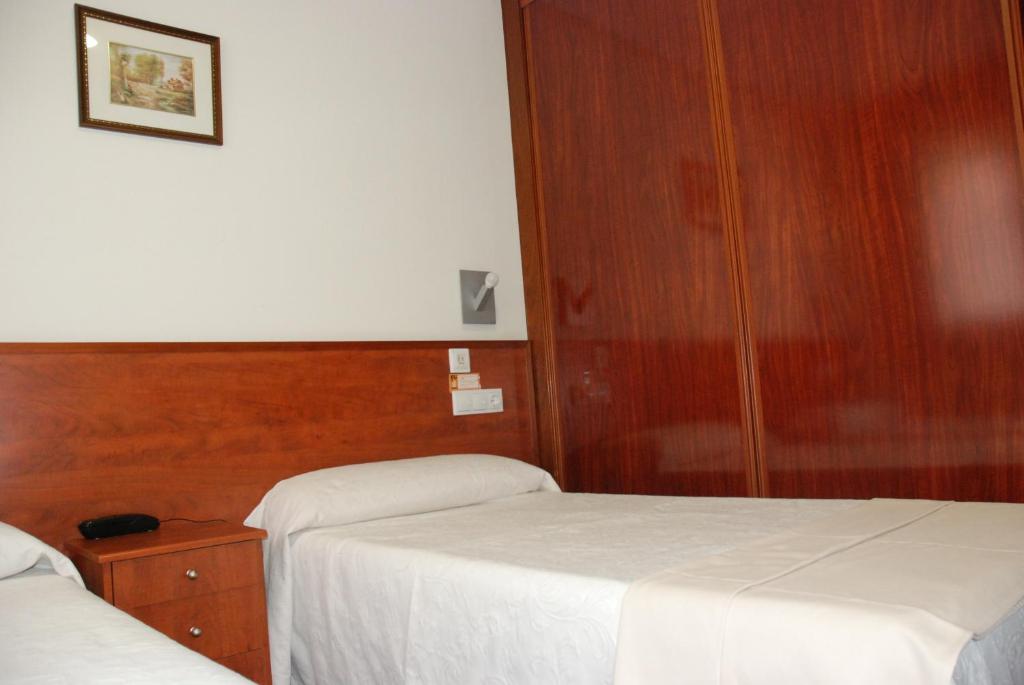 Postel nebo postele na pokoji v ubytování Apartahotel FC Catedral
