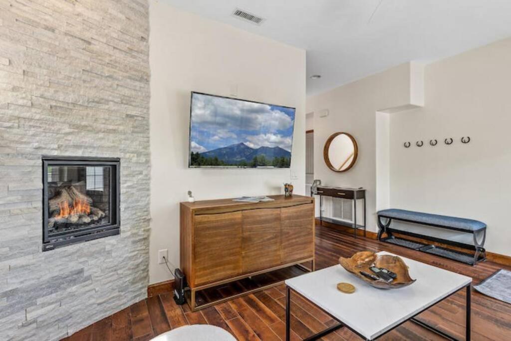 a living room with a fireplace and a couch at Verde St A in Flagstaff