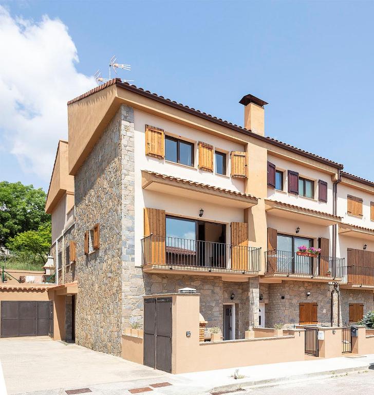 a large building with balconies on the side of it at Ca la Gloria in Vallcebre