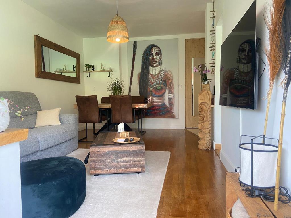 uma sala de estar com um sofá e uma mesa em La perle em Annecy