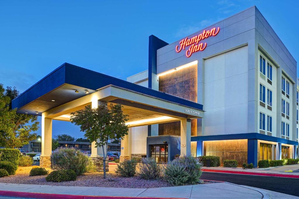 a front view of a hotel with a sign on it at Hampton Inn Albuquerque - University/Midtown in Albuquerque