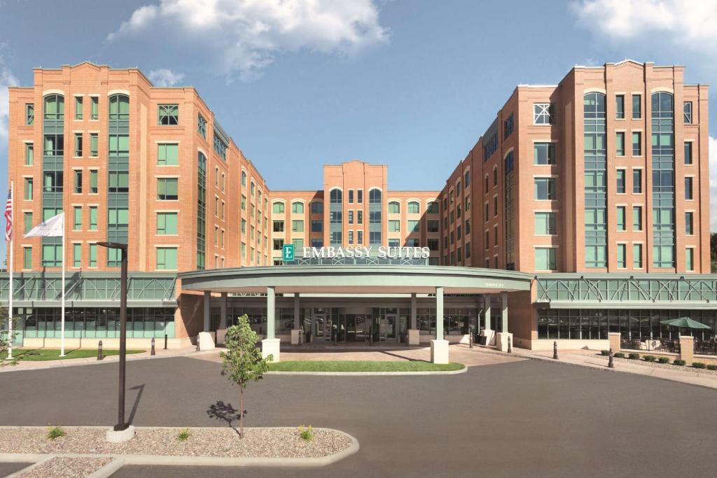 a rendering of a building with a parking lot at Embassy Suites Saratoga Springs in Saratoga Springs