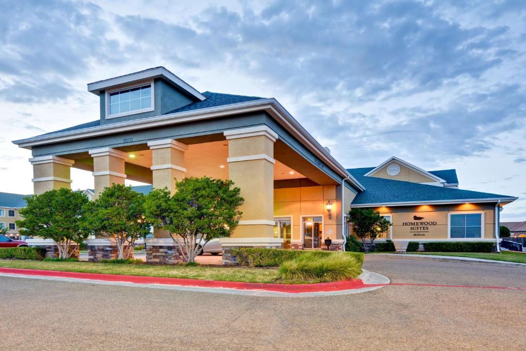 a large building with a blue roof at Homewood Suites by Hilton Amarillo in Amarillo