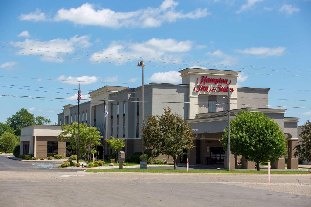 a building with a sign for a shopping center at Hampton Inn and Suites Alexandria in Alexandria