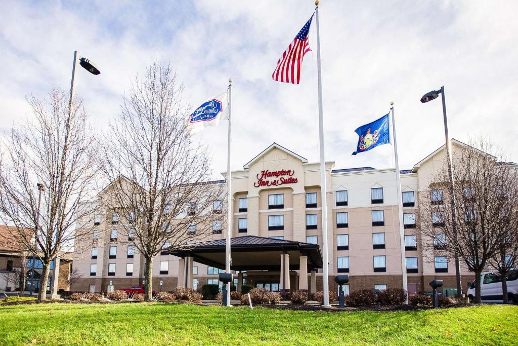 a hotel with american flags in front of it at Hampton Inn & Suites Blairsville in Blairsville