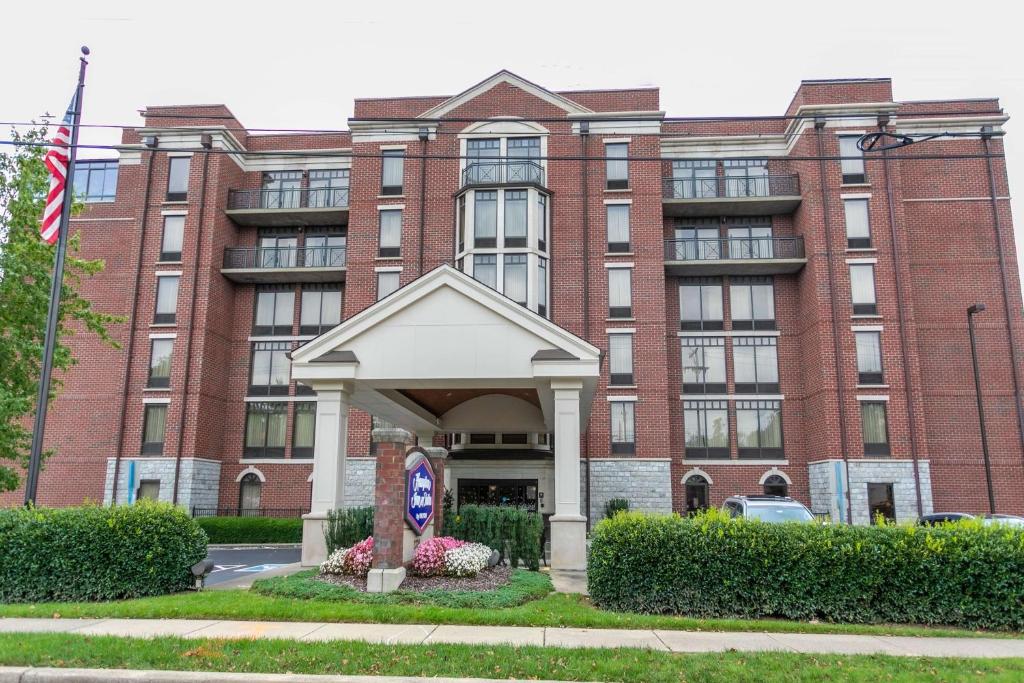 a large red brick building with a gazebo in front at Hampton Inn & Suites Nashville-Green Hills in Nashville