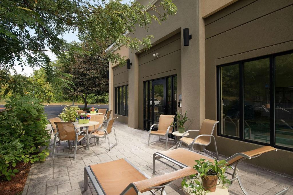 a patio with tables and chairs in a building at Hampton Inn Haverhill in Haverhill
