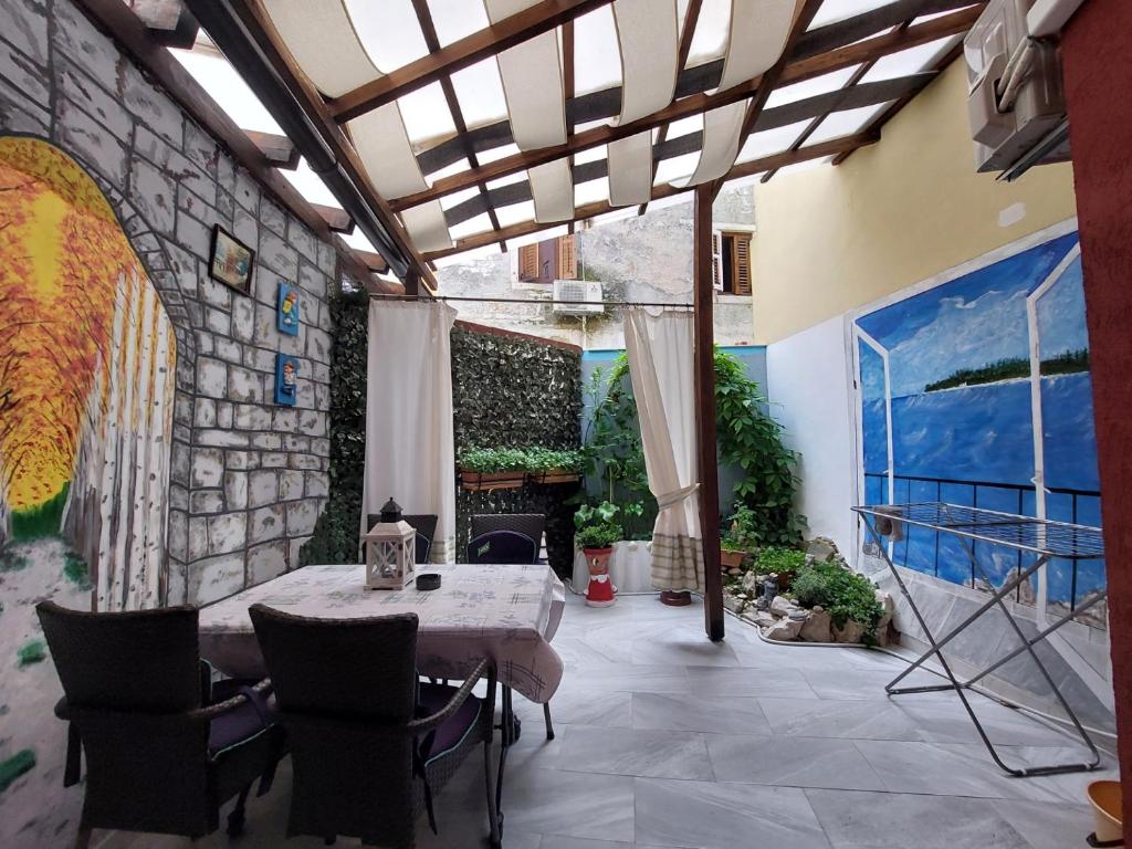 a patio with a table and chairs and a stone wall at Leona in Novigrad Istria