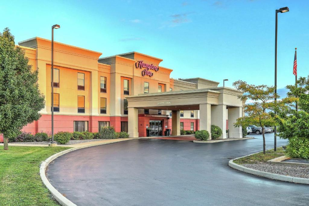 a building with a parking lot in front of it at Hampton Inn Batavia in Batavia