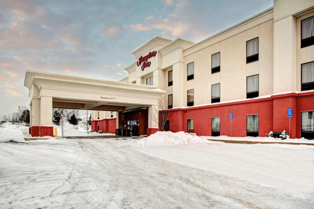 a hotel with snow in front of it at Hampton Inn Coldwater in Coldwater