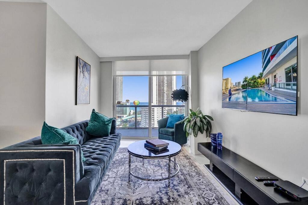 a living room with a couch and a table at Gorgeous 4 BDRM Condo Stunning Views Beach Access in Hallandale Beach