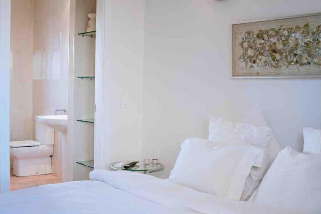 a white bedroom with a bed and a sink at Experience beautiful duplex penthouse with terrace in Palma in Palma de Mallorca