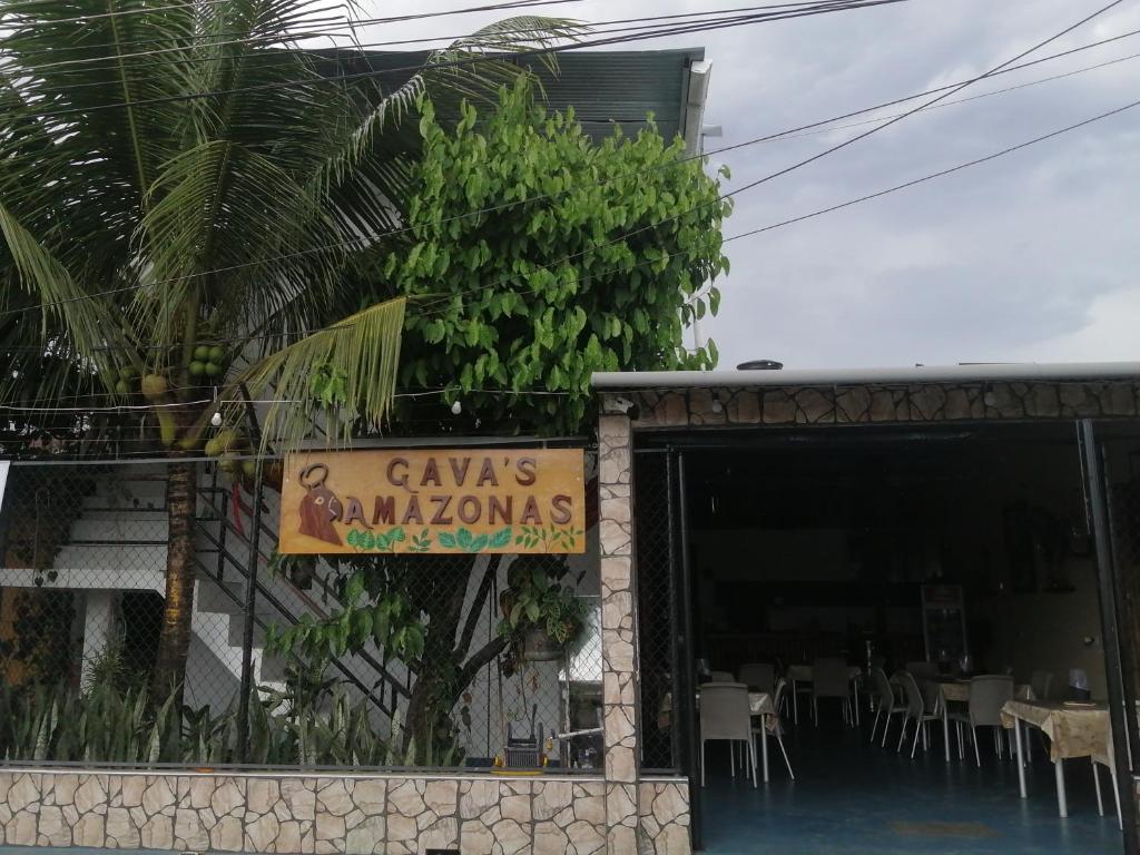 a sign for a restaurant in front of a building at Hotel Gavas Amazonas in Leticia