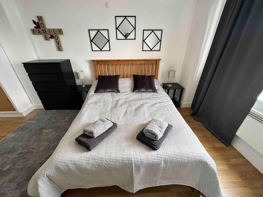 um quarto com uma cama grande com duas almofadas em Bright and cosy 1 bed flat next to Tower Bridge em Londres