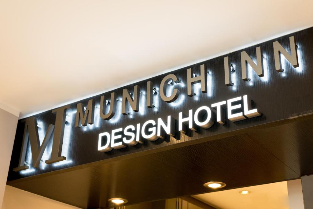 a sign for a luxury hotel in a building at Hotel Munich Inn - Design Hotel in Munich