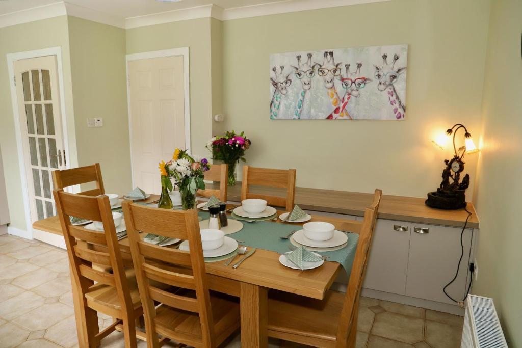 a dining room with a wooden table and chairs at Centrally located house on Ring of Kerry in Killorglin