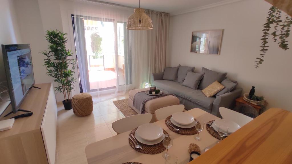 a living room with a couch and a table at Heydays Apartment in La Mata