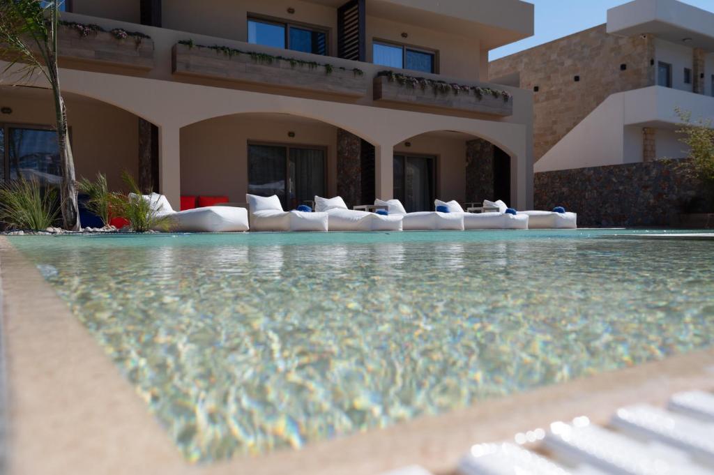 a house with a swimming pool with lounge chairs in it at Prasonisi Light House Boutique Hotel in Prasonisi
