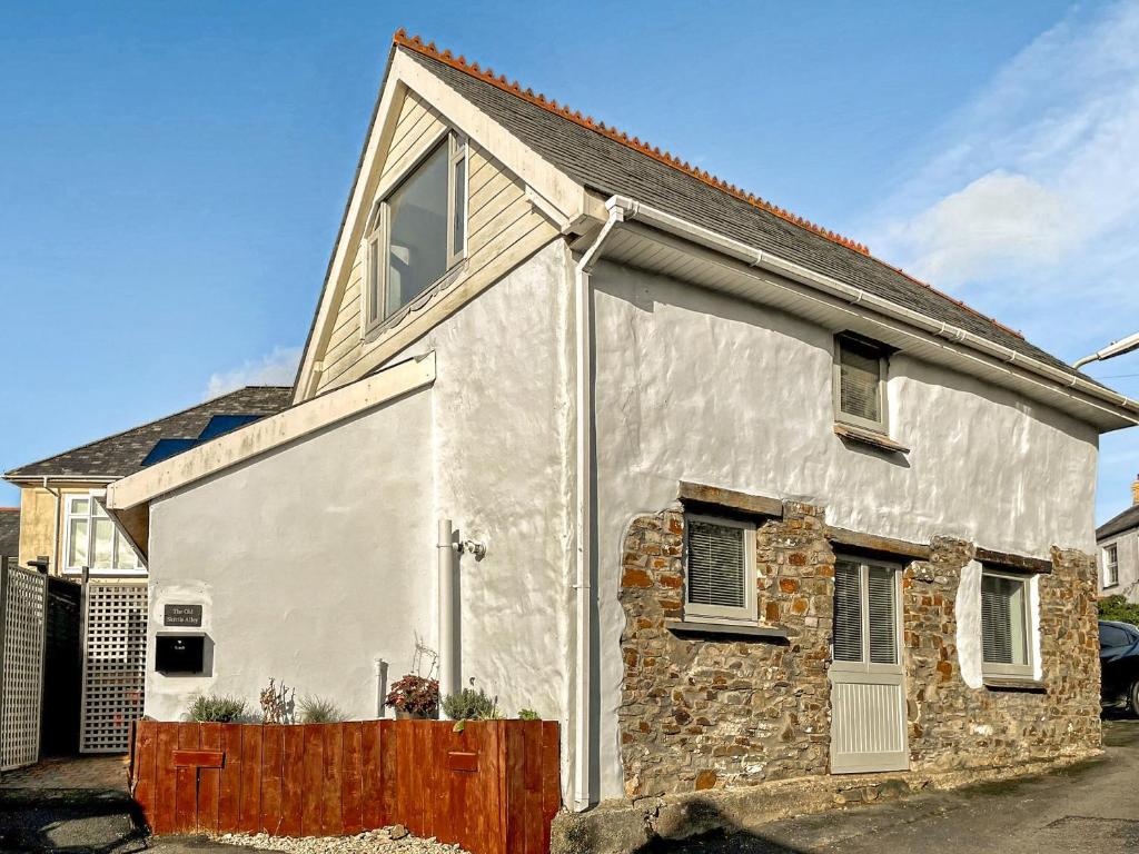 a white house with a stone wall at Old Skittle Alley in High Bickington