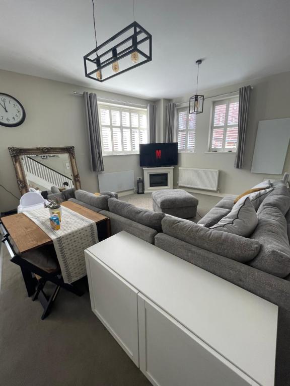 a living room with a couch and a table at Central Mews House Altrincham in Altrincham