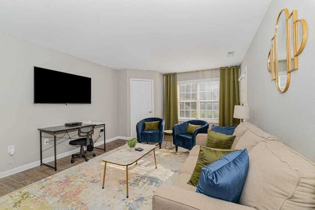 a living room with a couch and a desk at King Beds 2- Smart TVs-Free Parking-Patio in Greensboro