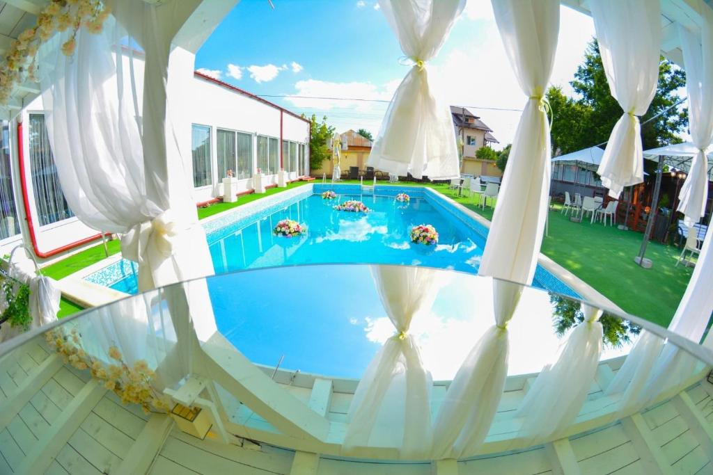 a view of a swimming pool from the balcony of a house at Pensiune Valentina in Râmnicu Vâlcea