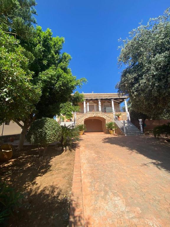a large house with a driveway in front of it at Casa Maleda in Hornachuelos