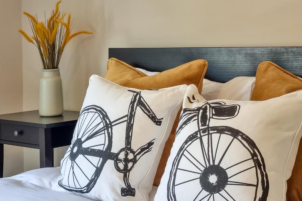 a black and white bicycle pillow on a bed at The Bs Cycle, 4 Bedroom, 2 Bathroom, House in Harrogate Centre in Harrogate