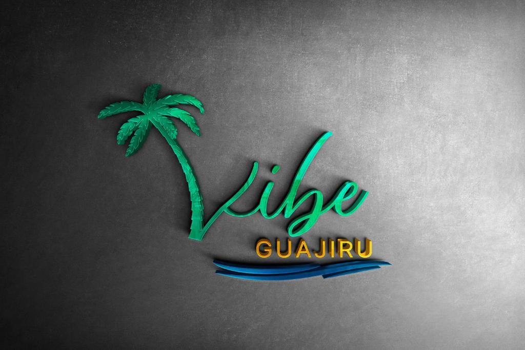 a palm tree on a wall with the word like cuirrh at Pousada Vibe Guajiru in Trairi