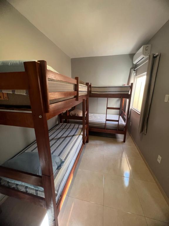 a room with two bunk beds and a window at Nos Lençóis Dunas Residence 9 in Santo Amaro
