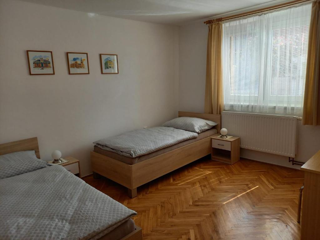 a bedroom with two beds and a window at Ubytování Na Kopci in Uherské Hradiště